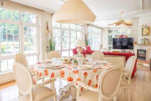 a baby sitting at a table in a living room at Villa familiar - Jacuzzi - Children's Area in Bacoy