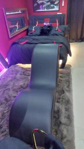 a bedroom with a bed and a cat laying on it at Love room les pins in Le Muy