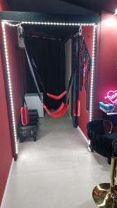 a gym with two hammocks in a room with red walls at Love room les pins in Le Muy