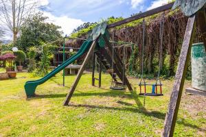 a playground with a slide in a yard at Villa familiar - Jacuzzi - Children's Area in Bacoy