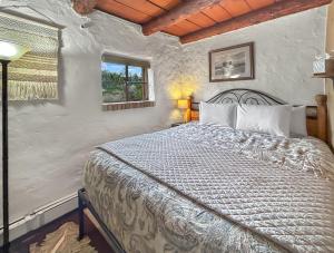 a bedroom with a bed and a window at Casita Adobe in Grand Junction +31 photos