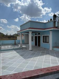 a small blue building with a large patio at The Celestine Villa in Thūr +1 photo