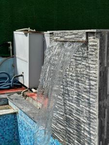 a water hose is coming out of a wall at The Celestine Villa in Thūr