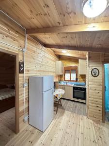 a kitchen with a refrigerator in the middle of a room at Guesthouse Katerina in Përmet