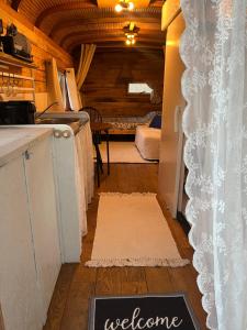 a kitchen with a refrigerator and a table in a room at PipowagenSiëester in Ommen