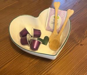 a heart shaped plate with two spoons and other items at PipowagenSiëester in Ommen +9 photos