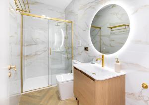 a bathroom with a shower and a sink and a mirror at Apartamentos El Marqués in Granada +113 photos