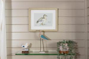 a picture of a bird sitting on a glass shelf at Keer Lodge a lakeshore haven Pine Lake Resort in Carnforth +40 photos
