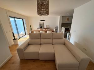 a living room with a couch and a table at Sea Breeze - Espinho Beach in Espinho +7 photos