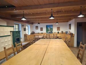 a large room with a wooden table and chairs at Chata pod Červenou studňou in Banská Štiavnica