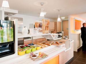 a kitchen with a counter with food on it at ibis budget Bayreuth in Bayreuth