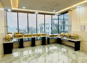 a buffet line in a room with large windows at Hotel The Skyluxe in Agra