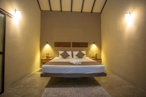 a bedroom with a large bed with two night stands at Hill Top Legacy in Ambalangoda
