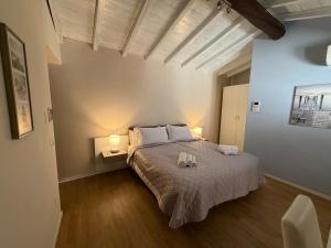 a bedroom with a large bed with two lamps at Corte Al Lago in Moniga