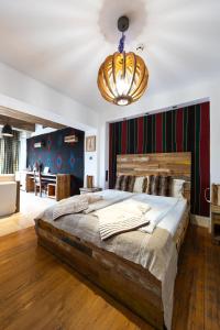 a bedroom with a large bed and a chandelier at Boutique Hotel Casa Art in Oreshak +256 photos
