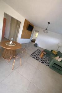 a living room with a table and a couch at Maison Dousè in Sainte-Rose
