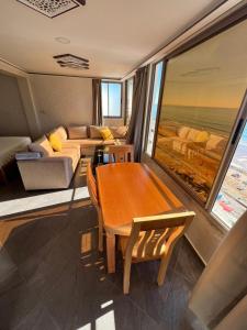 a living room with a couch and a table at private apparemment with ocean view in Taghazout +4 photos