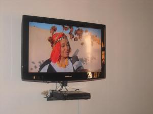 a television with a picture of a woman on it at Dar Aicha in Tahannout