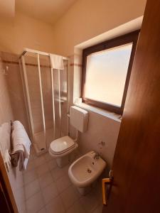 a bathroom with a toilet and a shower and a sink at Hotel e Ristorante Cassone in Malcesine +62 photos