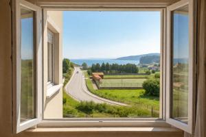 an open window with a view of a road at Nova MSuites Catedrales in Foz