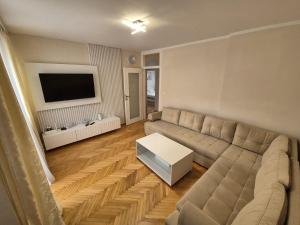 a living room with a couch and a tv at Amigo Apartment in Mostar