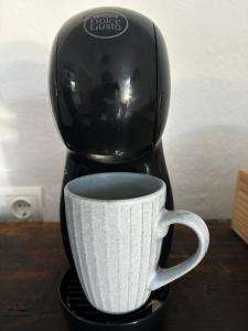 a coffee maker sitting on top of a coffee cup at Ibizan Style Studio in Jesús in Nuestra Señora de Jesus