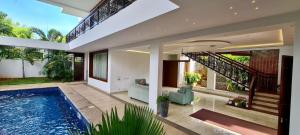 a house with a swimming pool and a staircase at Villa Escape In in Kuilapayam