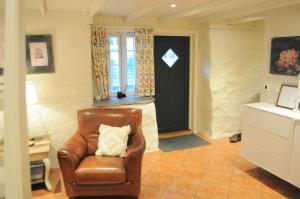 a living room with a chair and a door at Eldhuset in Stavanger