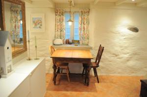a dining room with a wooden table and chairs at Eldhuset in Stavanger