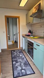 a kitchen with a kitchen rug on the floor at Ferienhaus Schoene in Hohnstein