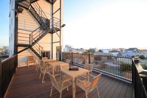 a balcony with tables and chairs on a building at APT Hotel Phan Rang in Phan Rang–Tháp Chàm