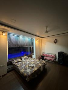 a bedroom with a large bed in front of a window at Infinity farm and garden in Bhopal