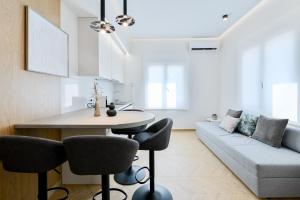 a living room with a table and chairs and a couch at Memoa Residence Preveza in Preveza
