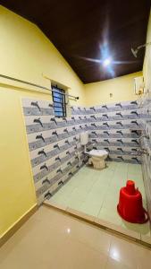 a bathroom with a toilet and a wall of towels at Gokarna Beach Vibes in Gokarn +10 photos