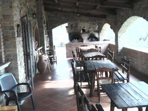 a restaurant with wooden tables and chairs in a building at Agriturismo Spinaruccoli in Cicerale