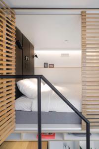 a bedroom with a bed in a small room at Zoku Vienna in Vienna