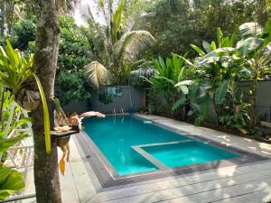 a swimming pool in the backyard of a house at Green villa in Galle