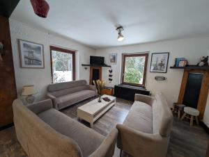 a living room with two couches and a table at Le CHALET Apart Hotel Autonome in Gerbépal