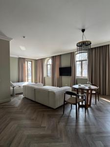 a large bedroom with a large bed and a table at Rambynas R36 SELF CHECK-IN in Panevėžys