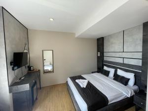 a hotel room with a bed and a television at Taksim Nu Pera Hotel in Istanbul