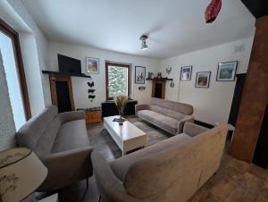 a living room with couches and a table at Le CHALET Apart Hotel Autonome in Gerbépal +23 photos
