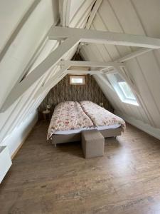 a bedroom with a bed in an attic at B & Buitenlust in Schagerbrug