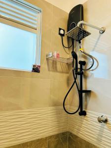 a shower with a blow dryer in a bathroom at Nushi Inn in Katunayaka