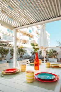a white table with plates and bowls on top of it at Velaria Boutique Apartment in Monopoli