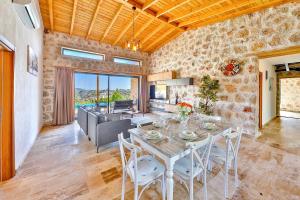 a kitchen and living room with a table and chairs at Patara breeze in Kaş