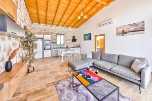 a living room with a couch and a table at Patara breeze in Kaş