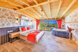 a bedroom with a bed and a tub in a room at Patara breeze in Kaş +41 photos