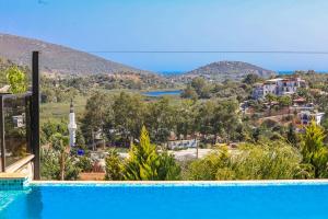 a swimming pool with a view of a city and mountains at Patara breeze in Kaş