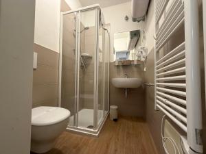 a bathroom with a shower and a toilet and a sink at Corte Al Lago in Moniga +37 photos