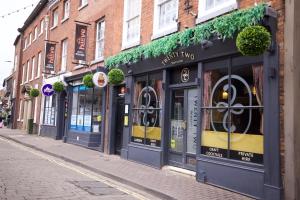 a row of shops on a city street at City Rooms by Hiive in Worcester